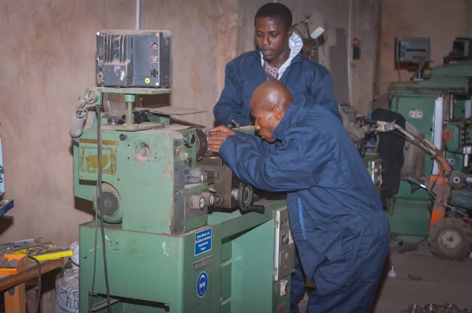 Polytechnic students using laptops and digital tablet, working together